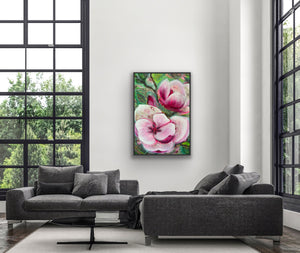 Floral painting on a wall above a gray sofa in a modern living room.