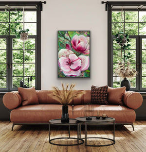 Living room with a brown sofa, round coffee table, and floral painting on the wall.