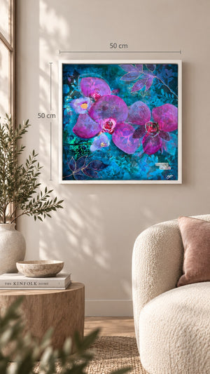 A framed floral wall art print hangs on a beige wall in a styled living room. The artwork shows large purple orchid flowers with pink centers over a vivid blue and teal textured background.