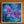 A framed mixed-media painting of purple orchids and blue leaves on a textured teal background, displayed on a wooden surface.