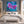 Abstract purple and blue floral art in bedroom setting. White floater frame. Modern living. Large floral art on the wall.