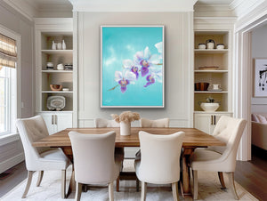 Dining room with a wooden table and white chairs, featuring a large floral painting on the wall.
