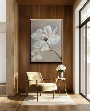 Modern interior with a beige armchair, side table, and floral artwork on a wooden wall.