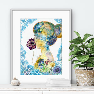 Framed artwork of a women face collage with flowers on a white wall.
