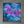A framed square painting featuring large purple orchid flowers over a textured turquoise and blue background, displayed against a gray wall.