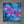 A square mixed-media painting of purple orchids and blue leaves on a textured teal background, displayed on a gray concrete wall.