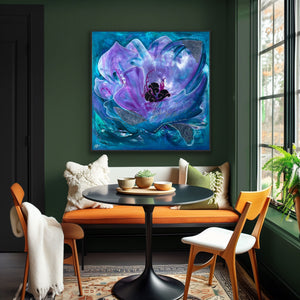 Modern interior with a large floral painting of a purple flower on a green wall, a bench, and chairs. 