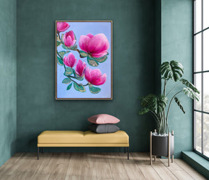 Luxury magnolia canvas print with pink flowers displayed on a deep green wall above a modern bench with a plant in a stylish interior