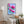 Luxury magnolia canvas print with soft pink flowers displayed in a calm neutral bedroom interior with soft textiles and elegant decor