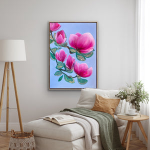 Luxury magnolia canvas print with soft pink flowers displayed in a calm neutral bedroom interior with soft textiles and elegant decor