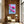 Luxury magnolia canvas print with soft pink flowers displayed in a warm wooden interior with a chair and natural light, elegant feminine wall art